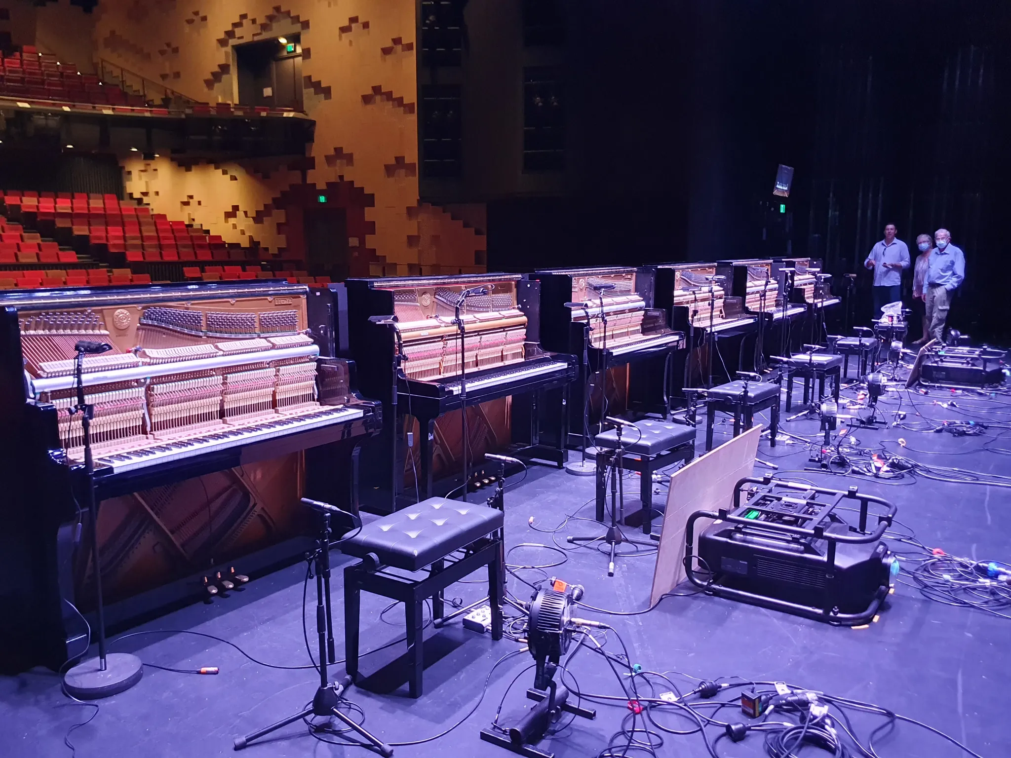 Six prepared pianos on stage during production setup